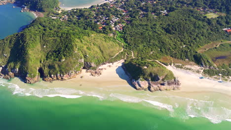 aerial view of lush forest and remote beach on ilha do mel, parana, brazil
