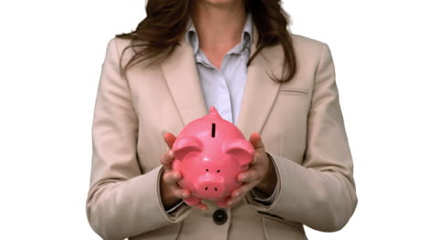 businesswoman throwing a piggy bank on white screen