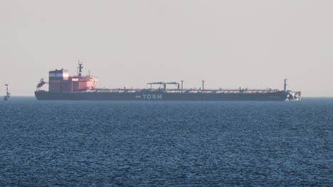 cargo ship moving across calm ocean waters