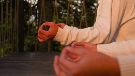 group gathers on rustic floor for meditation. yoga retreat attendees immerse in self-reflection pondering deep thoughts against pristine wilderness