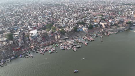 overhead capture of varanasi's iconic riverfront, where ancient temples rise above the bustling ghats and narrow lanes.