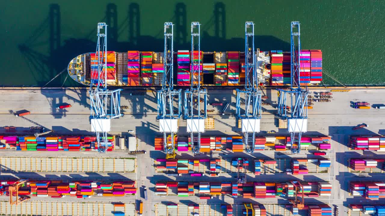 Container ship loading and unloading in deep sea port, Aerial top view of business logistic import and export freight transportation by container ship in open sea.