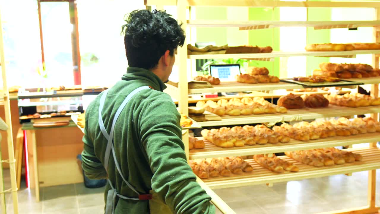 Baker arranging bread in a bakery