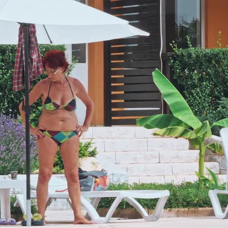 beautiful mature woman standing near pool