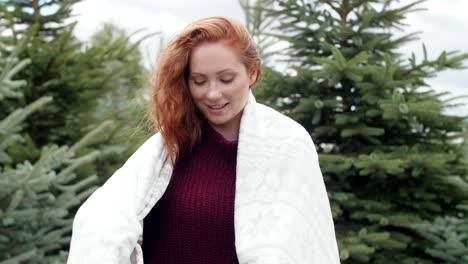 Woman-wrapped-in-blanket-outdoors