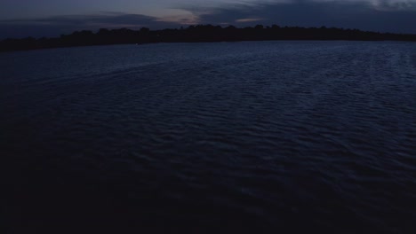 Aerial-tilting-up-shot-of-Midwestern-lake-at-twilight