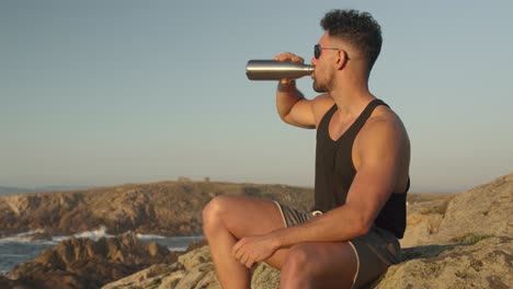 Tranquil-man-enjoying-seascape-in-summer-at-sunset