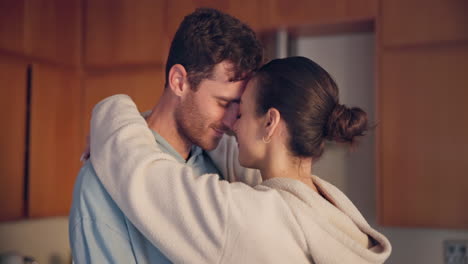 Couple,-hug-and-forehead-in-kitchen