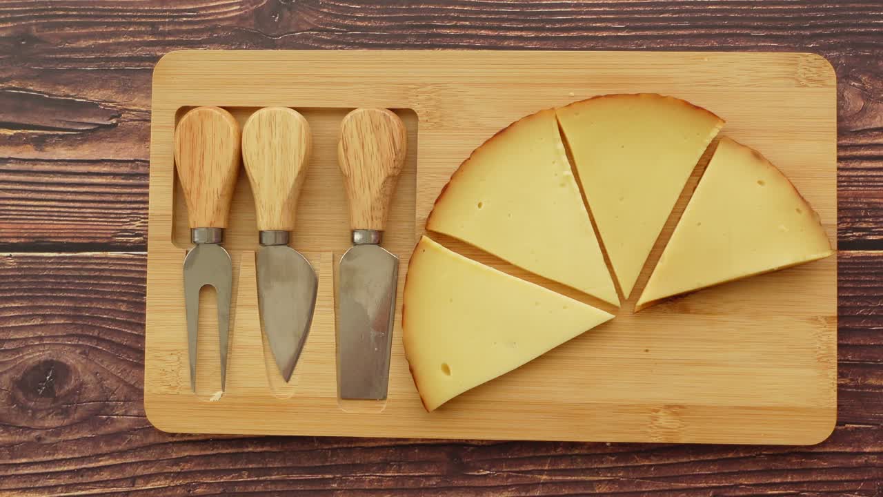 Cheese and cheese knives on a cutting board