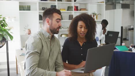 Colleagues-discussing-with-a-laptop