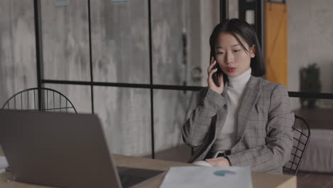 Asian Businesswoman Talking on Cellphone