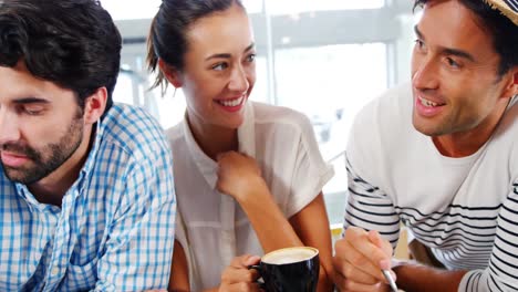 Group-of-friends-interacting-with-each-other-while-having-breakfast