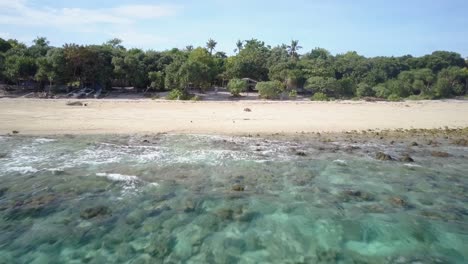 aerial forward tracking shot right above turquoise waters approaching beach of balicasag island, bohol, the philippines