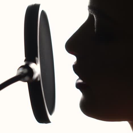 beautiful young singer who recorded a song in a professional recording studio. close-up face. square video
