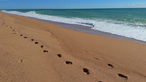 walking on the beach, footprints in the sand mediterranean sea, turquoise blue costa brava