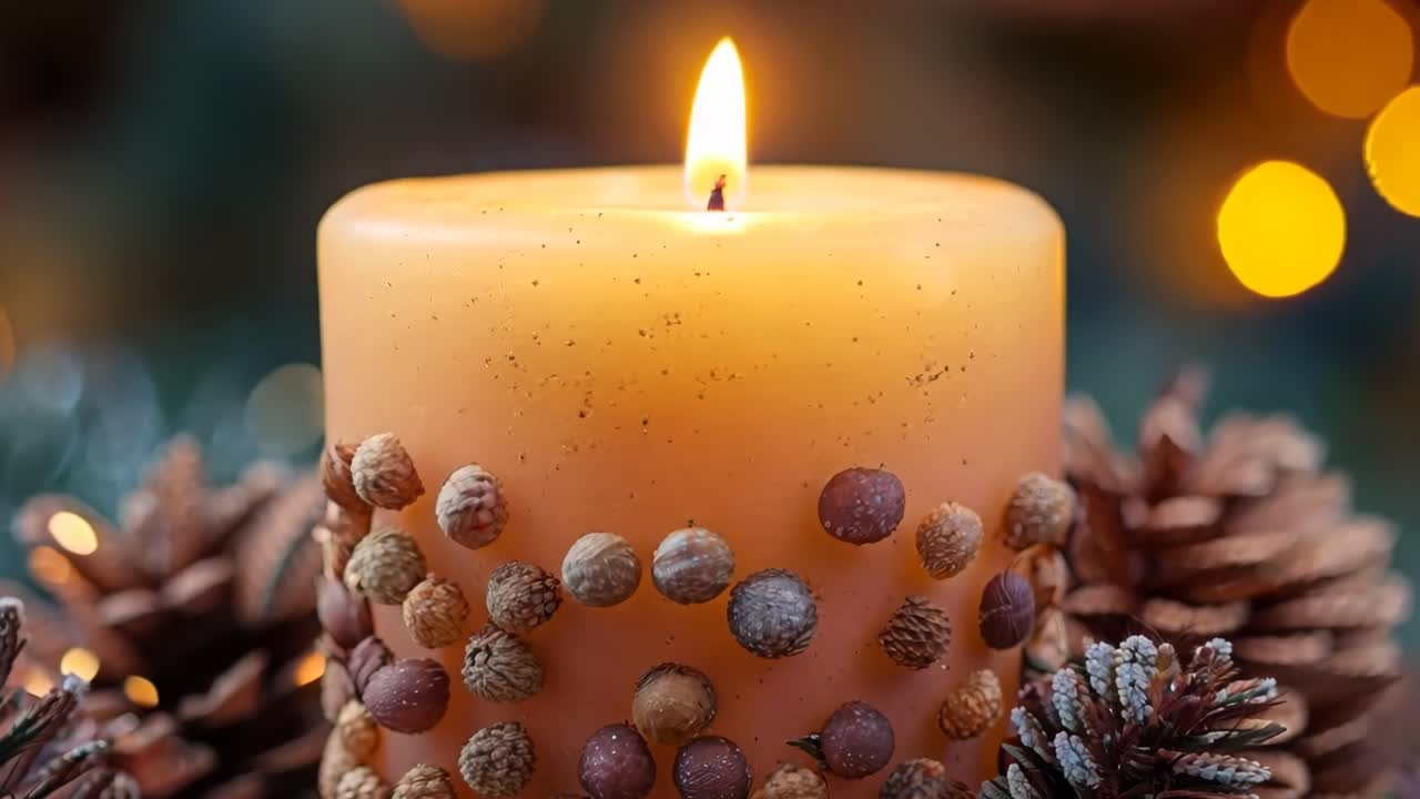 A candle with a wooden base and pine cones on top. The candle is lit and the pine cones are arranged around it. The scene has a warm and cozy atmosphere, perfect for a relaxing evening at home