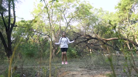 Athletic-Beautiful-Woman-Exercises-with-Jump,-Skipping-Rope-in-the-forest