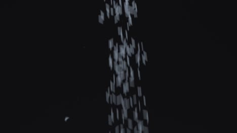 rice is falling down on black background in slow motion
