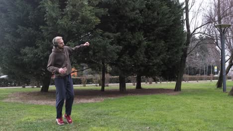 young man dancing on grass