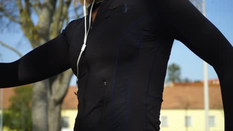 athletic young woman in sportswear training in park