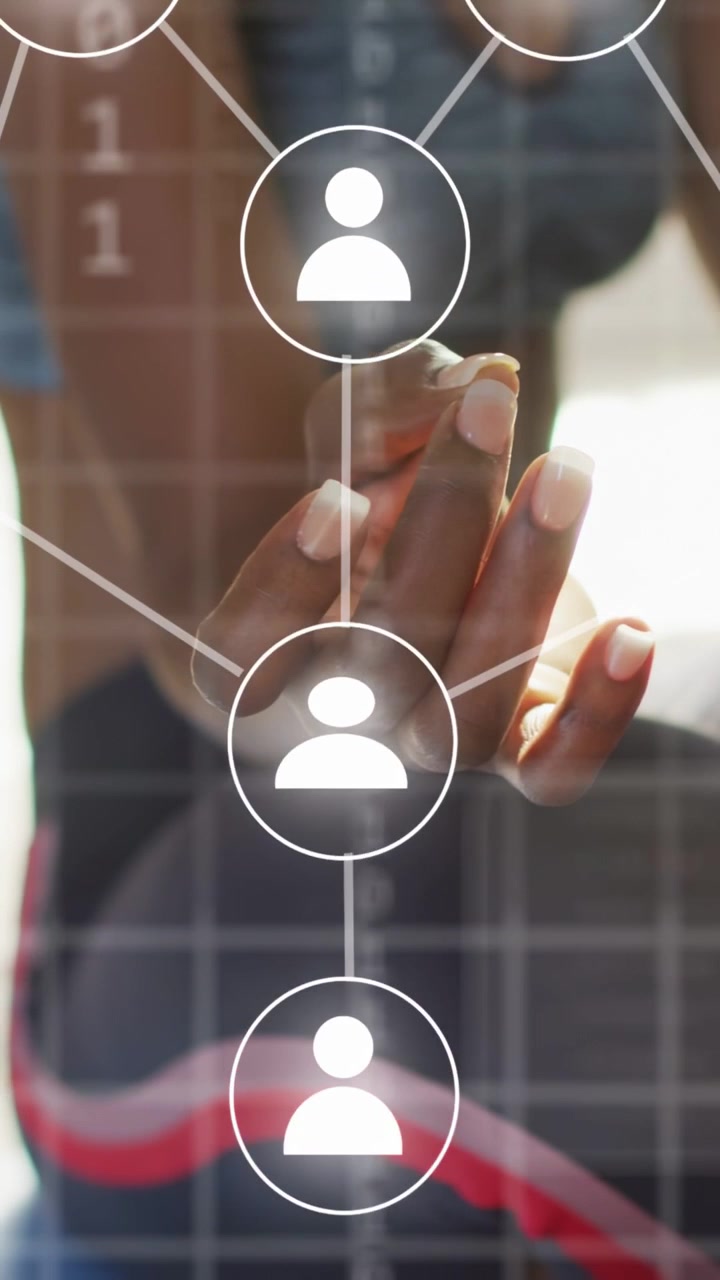 Vertical video: Woman tapping transparent panel, lighting user icons and forming network links