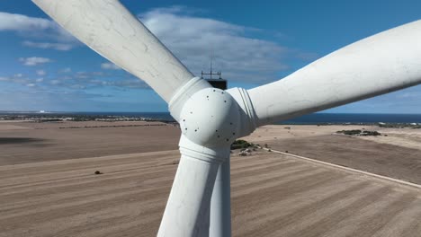 very close orbiting shot of wind turbines spinning