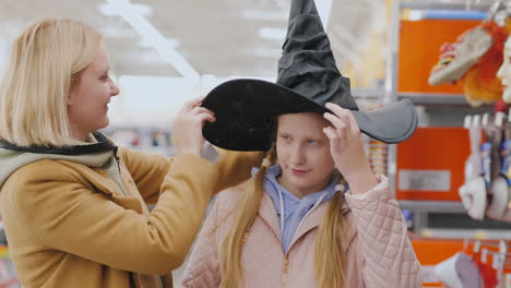 mother and daughter choose outfit for halloween