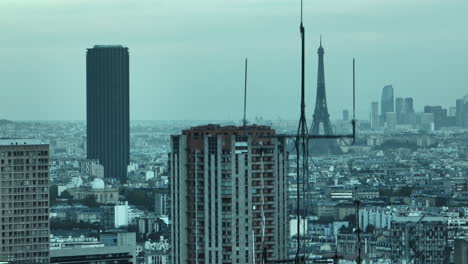 on a smoggy day, the eiffel tower emerges through the urban haze, a resilient