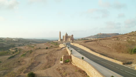 Beautiful-Brown-and-Beige-Colored-Church-Mediterranean-Countryside-on-Malta-Island,-Aerial-Establishing-Shot-forward-Dolly