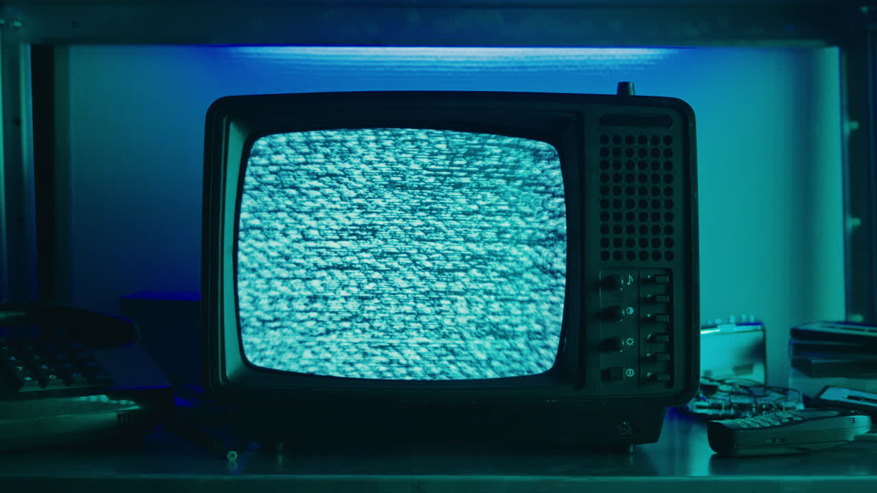 Retro TV, vintage television In a nostalgic setup, a retro TV displays grain on screen, scary halloween night device good for chroma key and green screen.