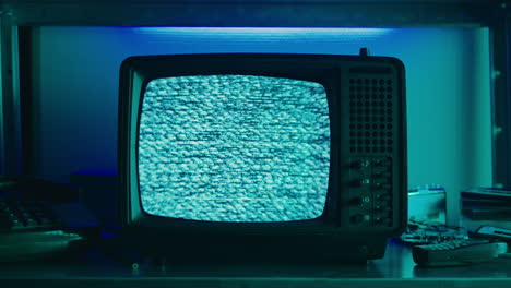 retro tv, vintage television in a nostalgic setup, a retro tv displays grain on screen, scary halloween night device good for chroma key and green screen.