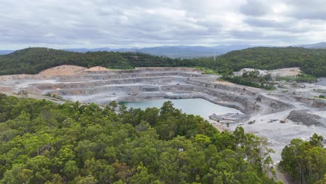 drone captures quarry surrounded by lush greenery