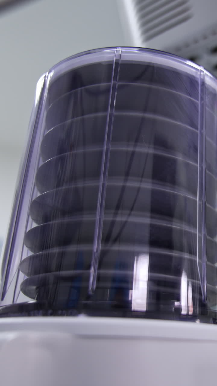 Doctor looks at the pump of lung ventilator machine. Medic separates ambu bag from a tube and the pump falls and stops. Low angle view. Blurred backdrop. Vertical video