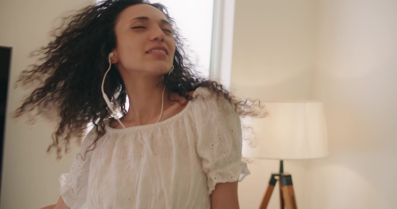Young woman with curly hair dancing