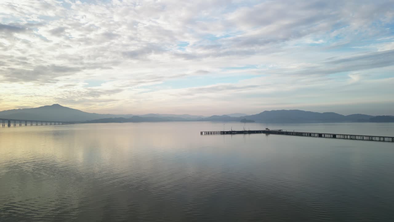 Aerial tracking left around pier near Richmond Bridge from Point Molate Beach Richmond California USA