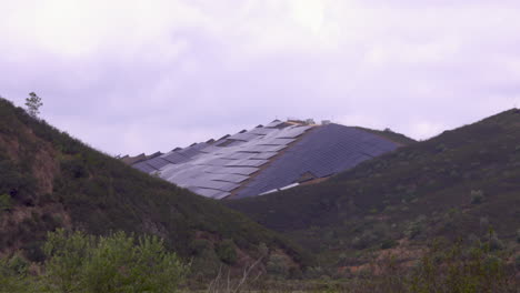 a large mountain completely covered with solar panels for sustainable energy