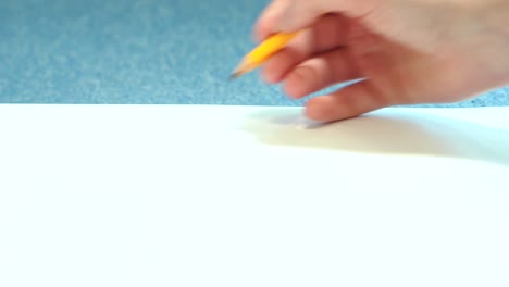 Girl doing pencil sketches on paper. Young woman learns to draw.