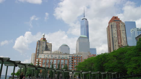 white clouds over world trade center in financial district of lower manhattan, new york city, united states