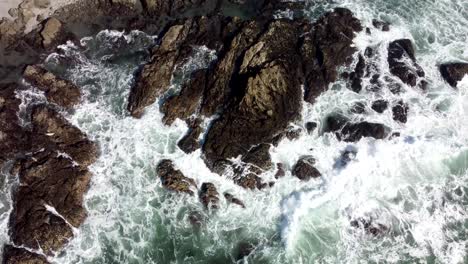 waves crashing against rocks on a cliffside