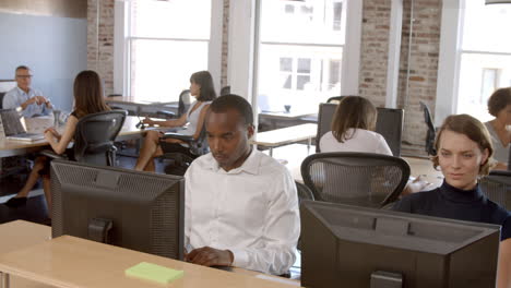 Businesspeople-Working-At-Computers-In-Busy-Modern-Office