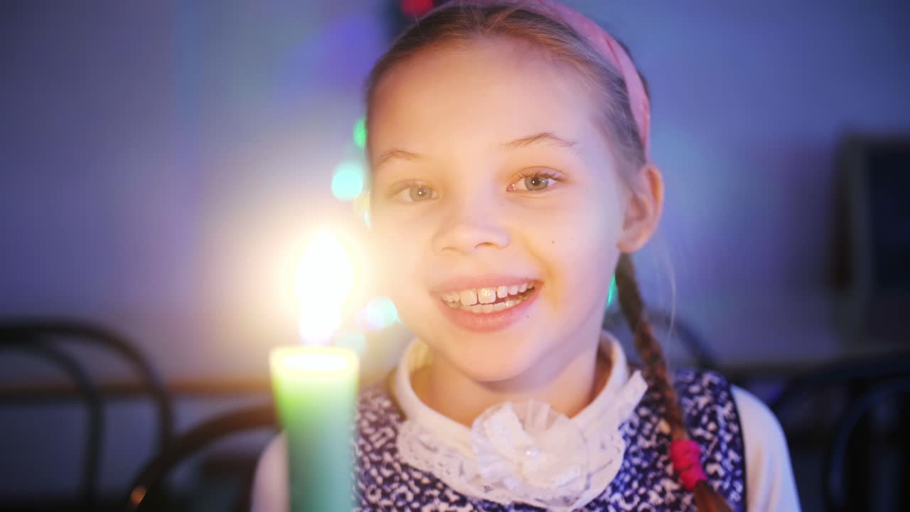 Smiling Girl Holding a Candle