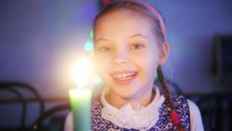 smiling girl holding a candle