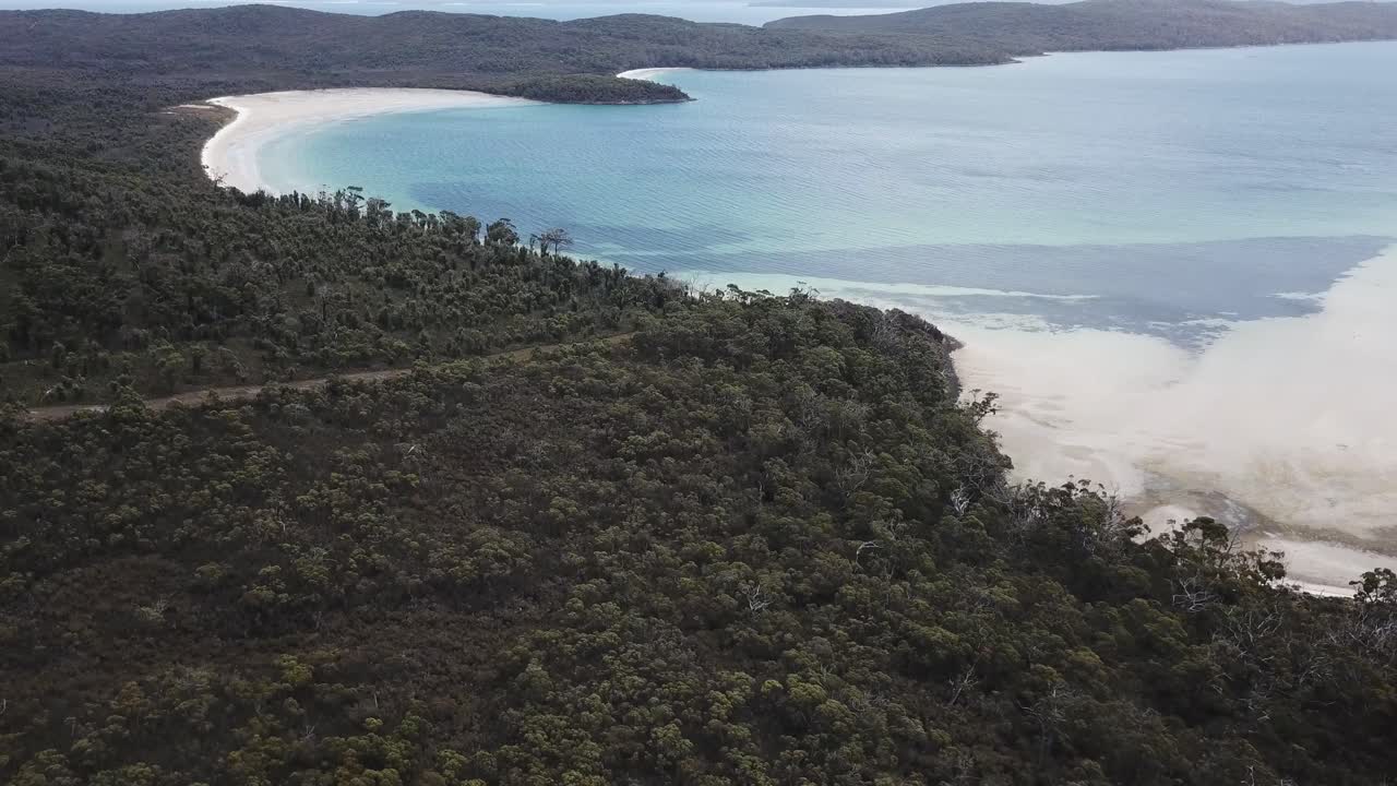 Aerial View of a Secluded Bay with White Sand Beach and Lush Coastal Forest