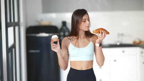 woman choosing between cupcake and croissant