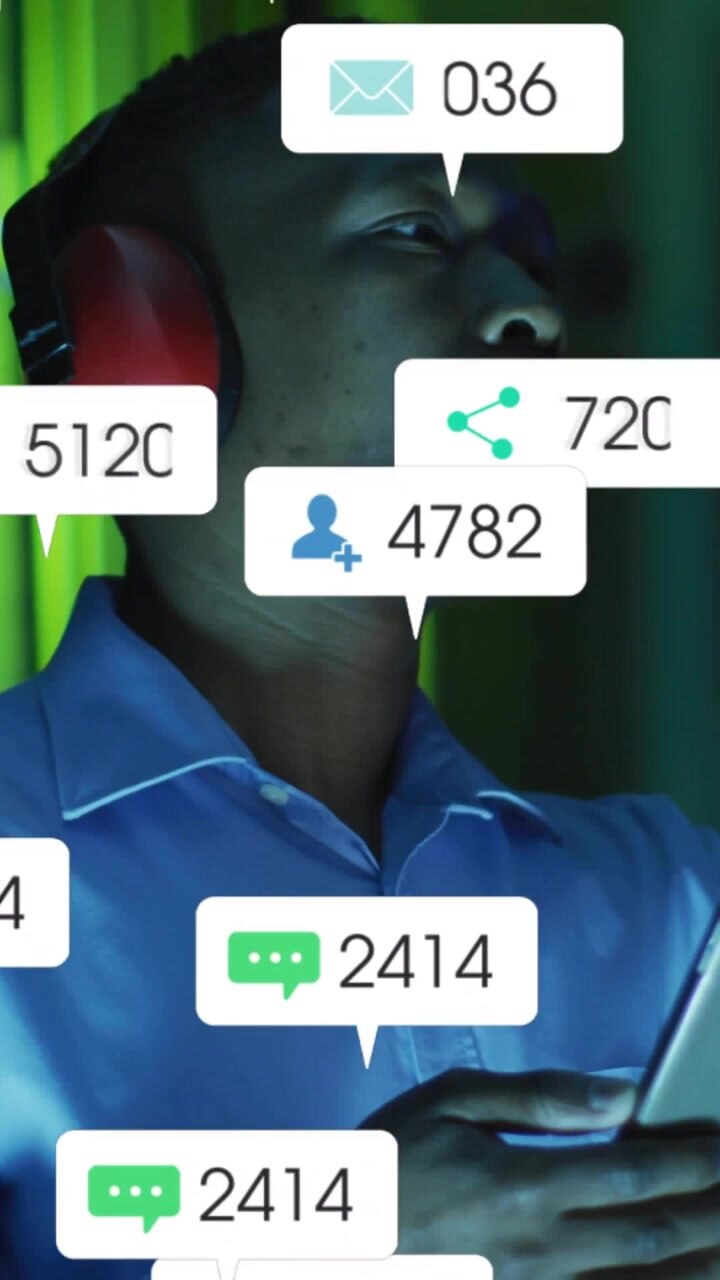 Vertical video: Man tapping phone viewing social media likes piling on device while tracking reach
