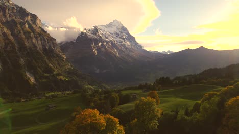 aerial drone footage dolly right to left over sycamore maple trees with stunning view of eiger north face and lenticularis clouds