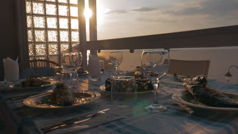 at sunset in city of perea greece dinner table served with cooked fish