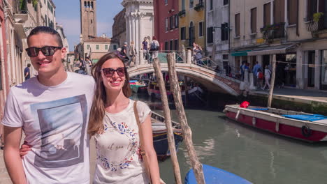 couple walking through venice canal