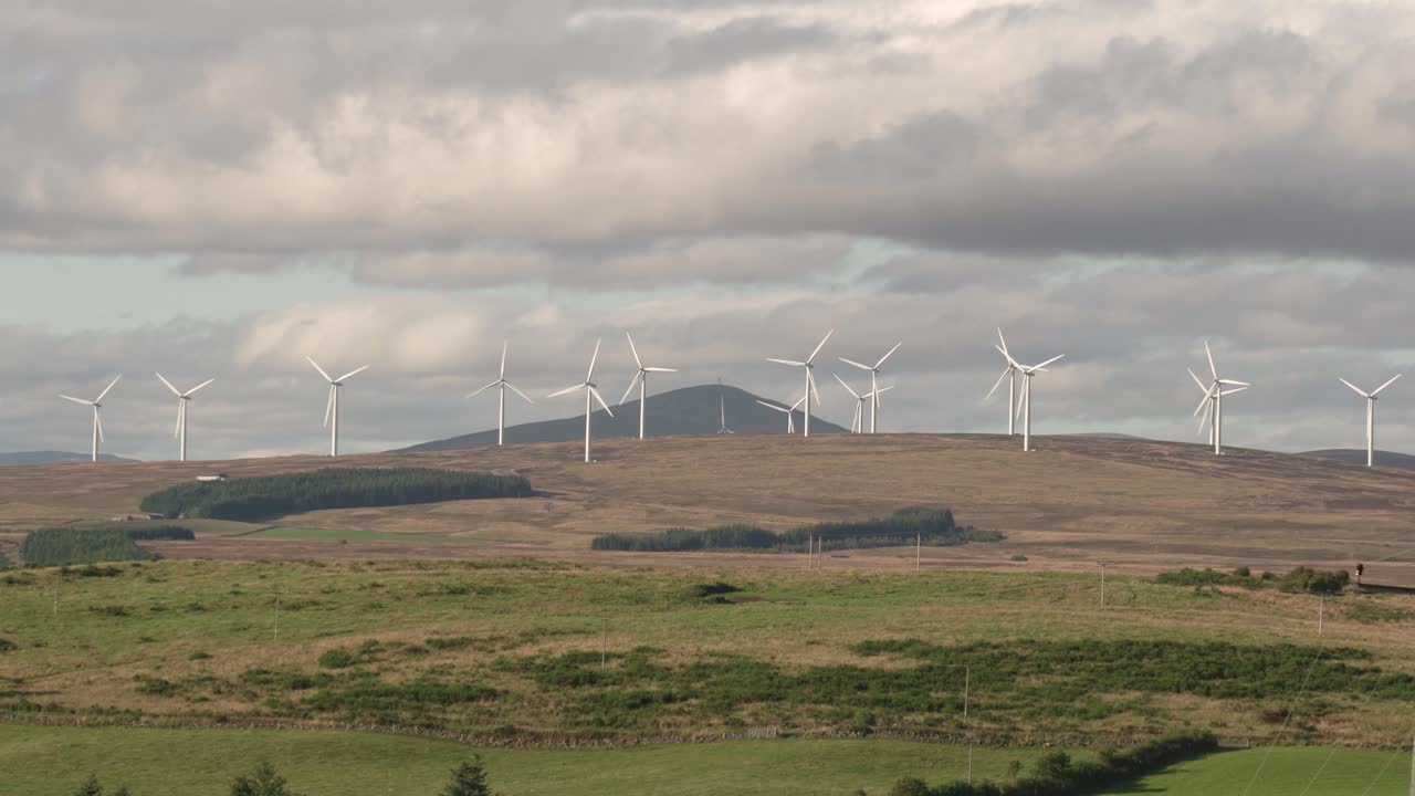 Wind Turbines on a Rural Hillside with Fields in the Foreground