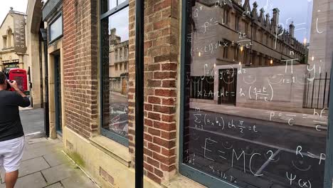 reflections and posters on a brick building